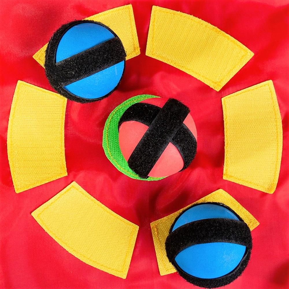 Close-up of sticky balls caught on the yellow and green Velcro target